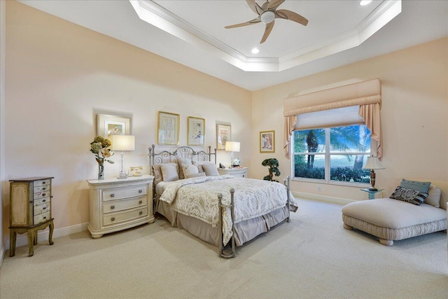 bedroom with a raised ceiling, crown molding, light carpet, and ceiling fan