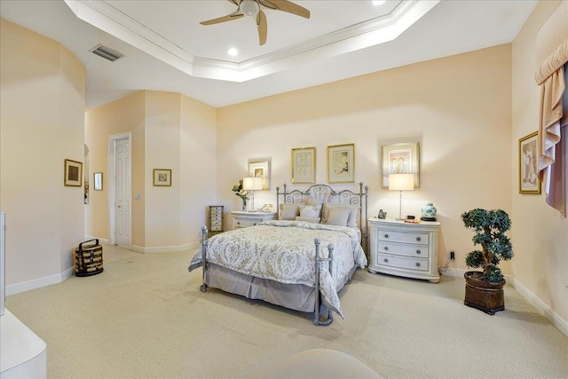 bedroom with a raised ceiling, ornamental molding, carpet, and ceiling fan