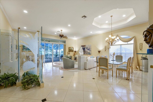 interior space with crown molding, a tray ceiling, and ceiling fan with notable chandelier