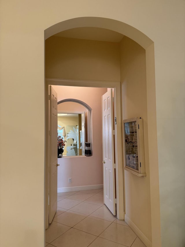 corridor with light tile patterned flooring