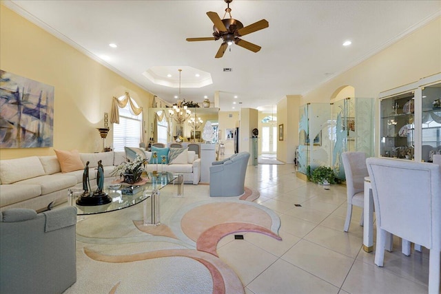 tiled living room with crown molding, a tray ceiling, and ceiling fan with notable chandelier