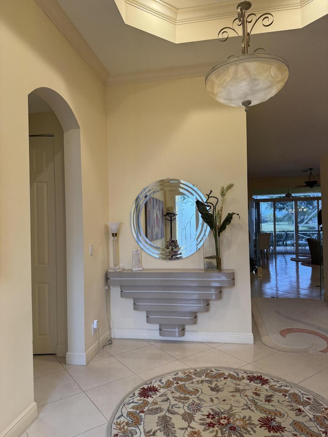 interior space with tile patterned floors and ornamental molding