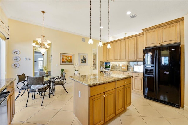 kitchen featuring a kitchen island, decorative light fixtures, ornamental molding, light stone counters, and black fridge with ice dispenser