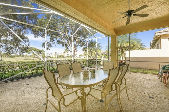 sunroom / solarium featuring ceiling fan