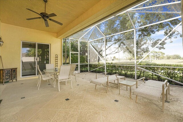 living room with ceiling fan and light tile patterned floors