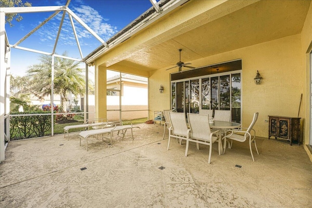 view of patio / terrace with ceiling fan and glass enclosure