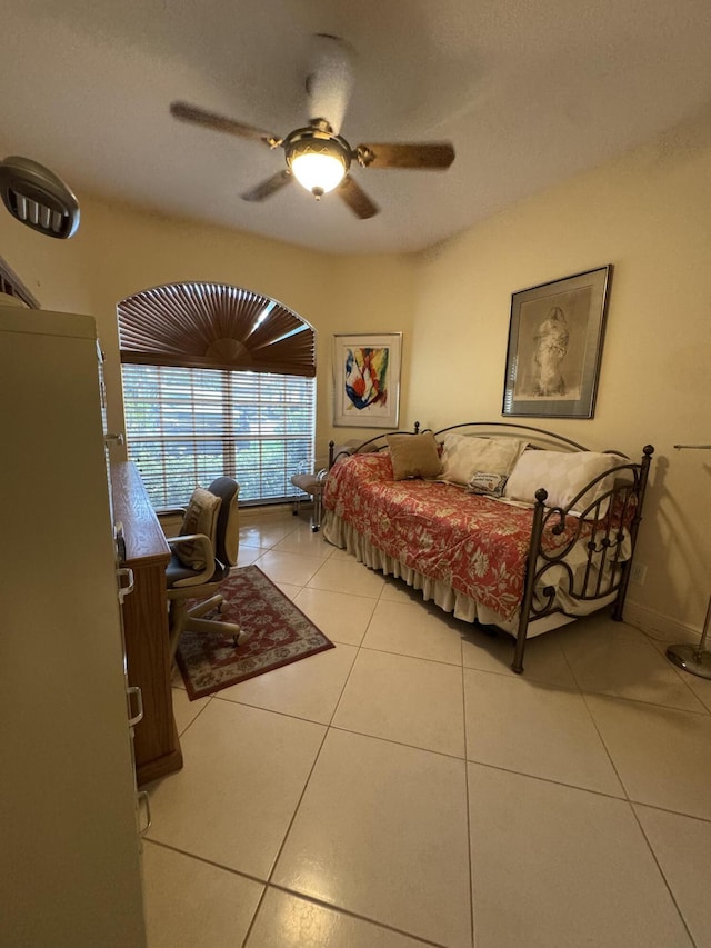 tiled bedroom with ceiling fan