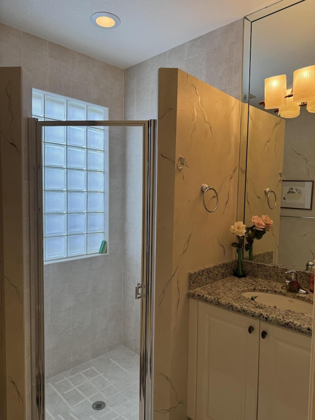 bathroom with vanity and an enclosed shower