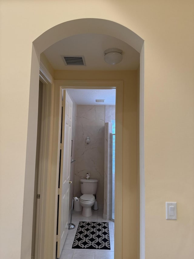 bathroom featuring toilet and tile patterned floors