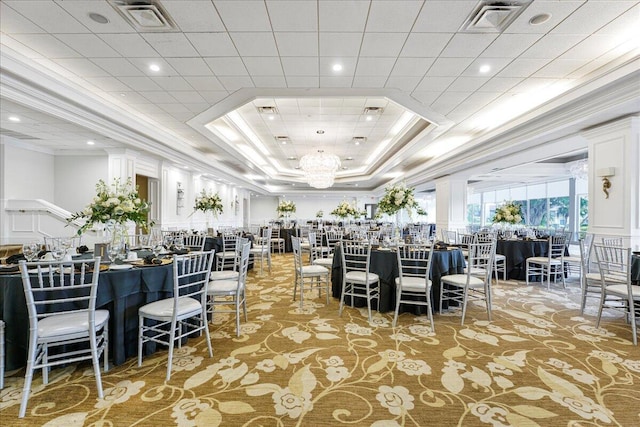 carpeted dining space with crown molding, an inviting chandelier, and a tray ceiling