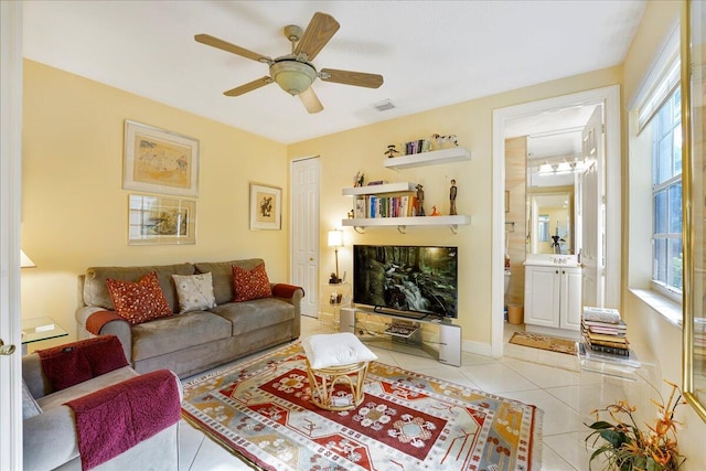 living room featuring light tile patterned floors and ceiling fan