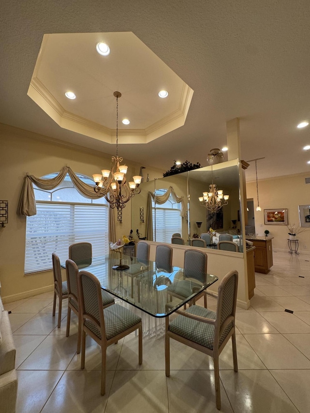 tiled dining space featuring a tray ceiling, a chandelier, and a healthy amount of sunlight