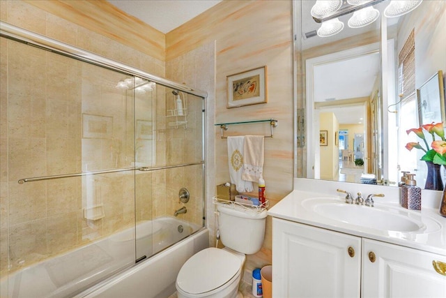 full bathroom with vanity, combined bath / shower with glass door, and toilet