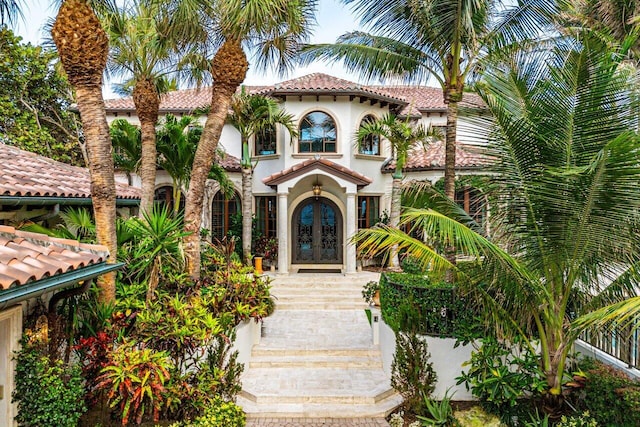 mediterranean / spanish-style house featuring french doors