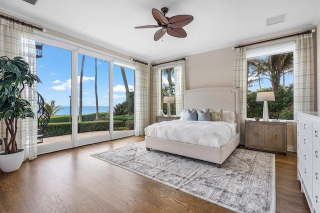 bedroom with crown molding, a water view, dark wood-type flooring, and ceiling fan