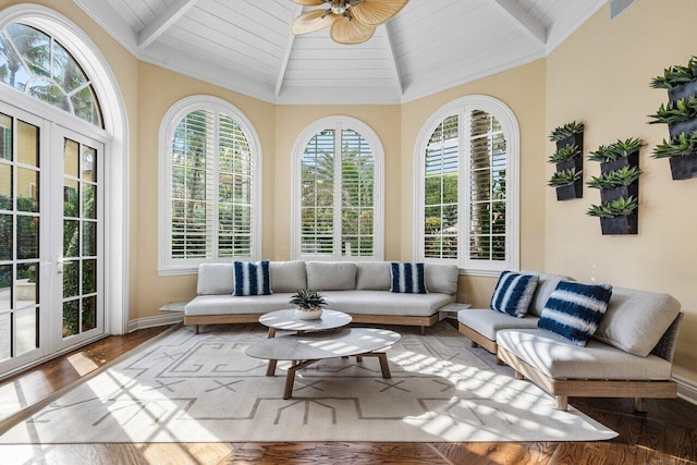 sunroom / solarium with vaulted ceiling, ceiling fan, and wood ceiling