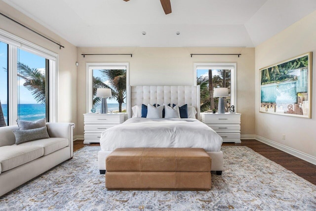 bedroom featuring a water view, ceiling fan, and hardwood / wood-style floors