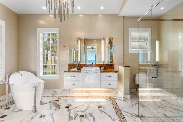 bathroom with vanity, shower with separate bathtub, and an inviting chandelier