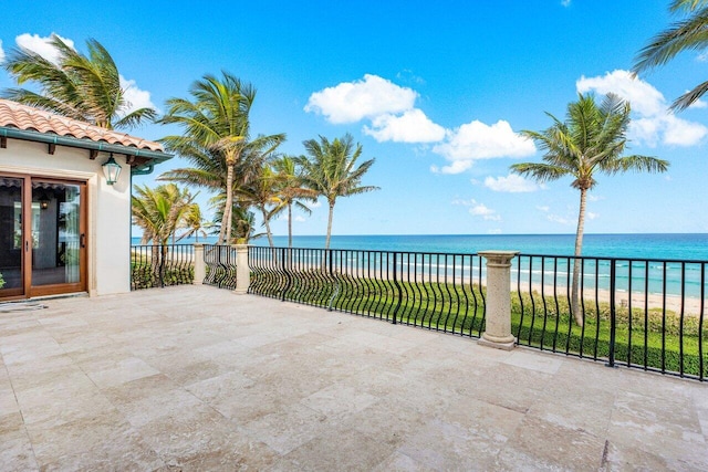 view of patio / terrace featuring a water view and a view of the beach