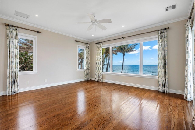 unfurnished room featuring hardwood / wood-style flooring, ornamental molding, a water view, and ceiling fan