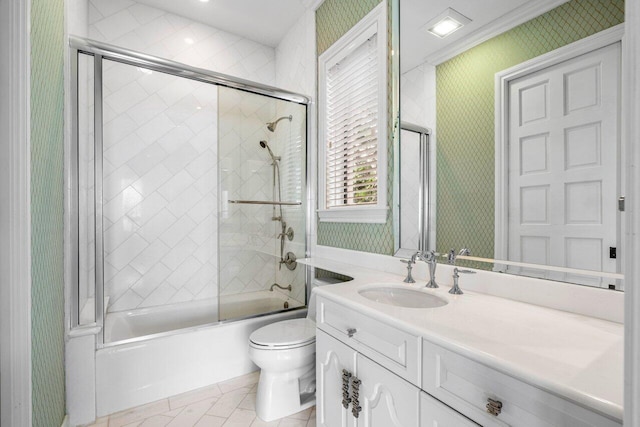 full bathroom with toilet, vanity, and shower / bath combination with glass door