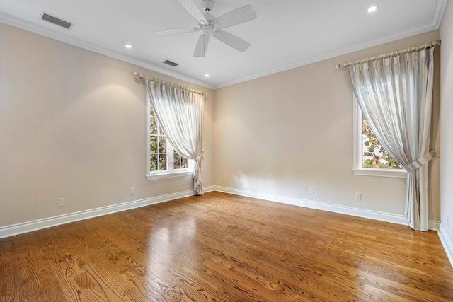 empty room featuring crown molding, ceiling fan, and hardwood / wood-style floors