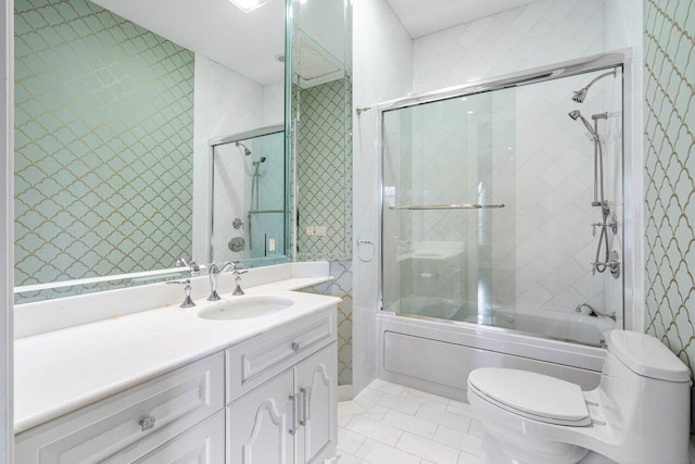 full bathroom featuring enclosed tub / shower combo, vanity, and toilet