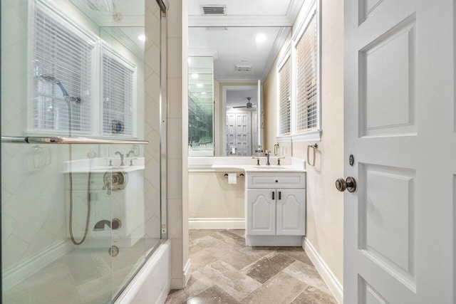 bathroom with enclosed tub / shower combo, vanity, and ornamental molding