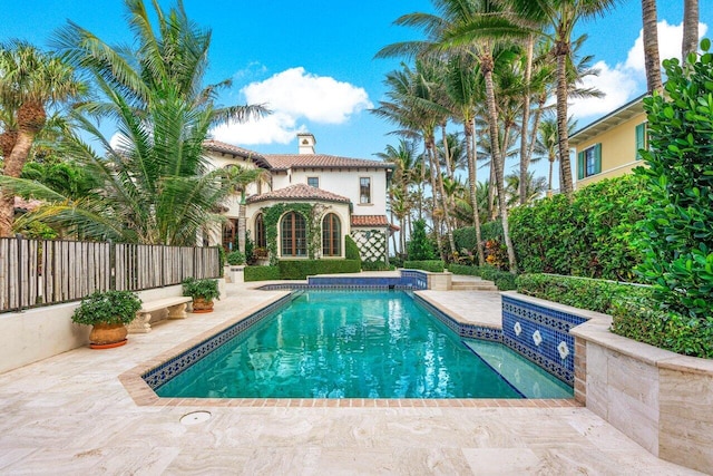 view of swimming pool featuring a jacuzzi and a patio