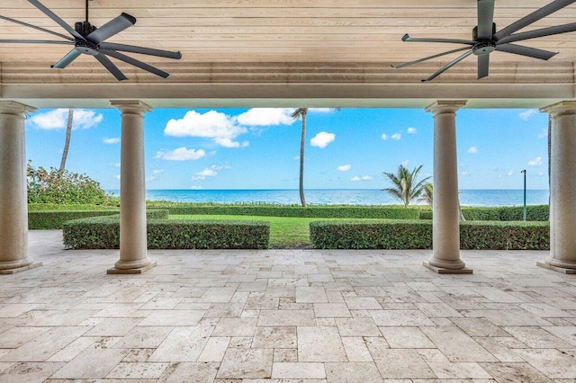 view of patio / terrace featuring ceiling fan and a water view