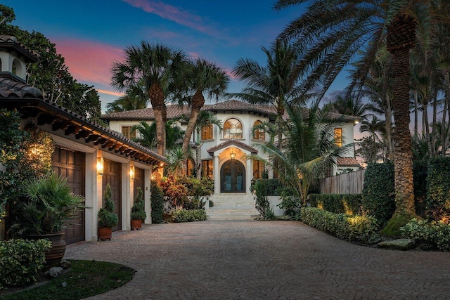 mediterranean / spanish home featuring a garage