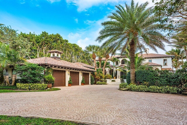 mediterranean / spanish-style house with a garage