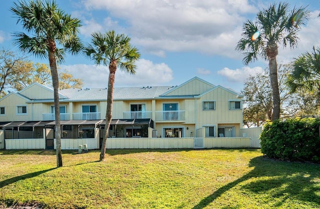 rear view of property featuring a yard