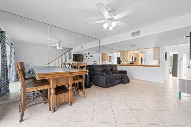 dining room with ceiling fan and light tile patterned floors