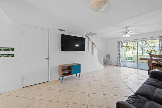 living room with light tile patterned floors and ceiling fan