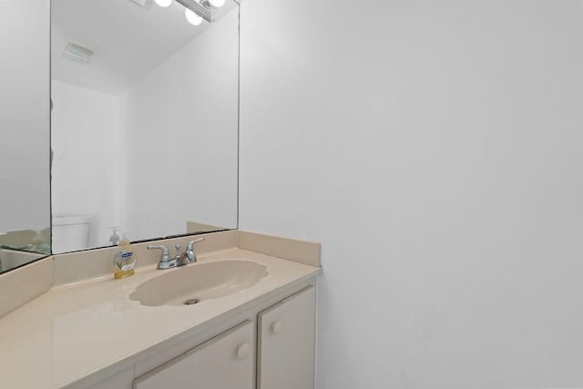 bathroom featuring toilet and vanity