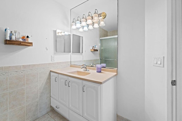 bathroom featuring tile patterned floors, tile walls, vanity, and walk in shower