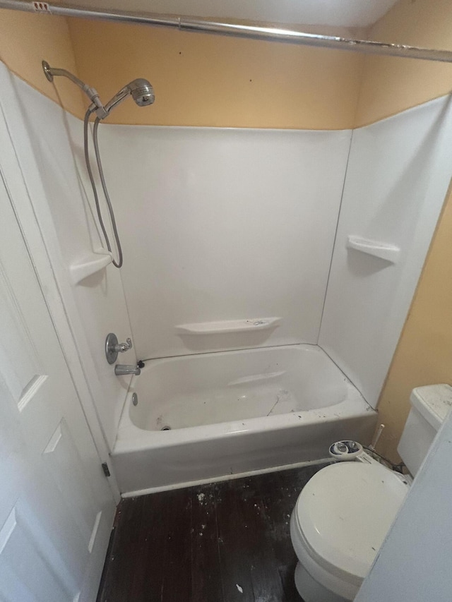 bathroom featuring toilet, shower / tub combination, and hardwood / wood-style flooring