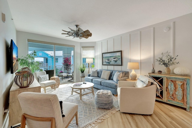 living room with ceiling fan and light hardwood / wood-style floors