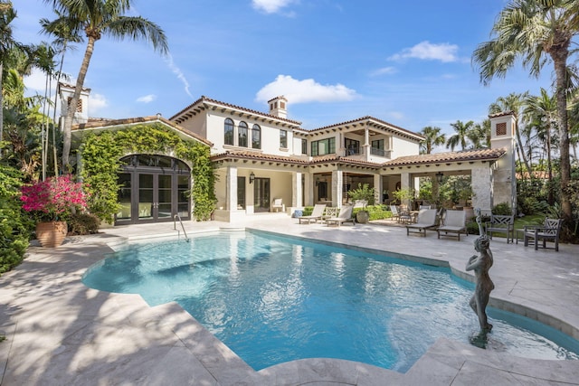 view of swimming pool with french doors and a patio