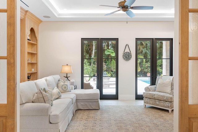 living room featuring ceiling fan, french doors, built in features, and a wealth of natural light