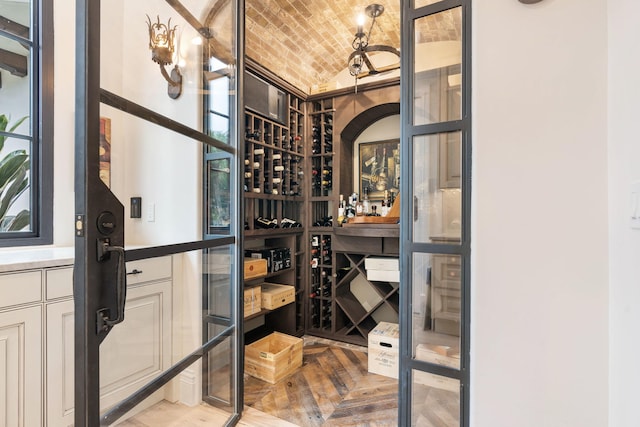 wine room with brick ceiling and vaulted ceiling