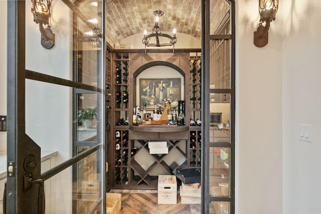 wine room with brick ceiling and lofted ceiling