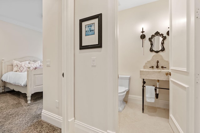 bathroom with toilet and ornamental molding