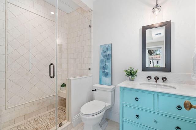 bathroom with toilet, vanity, tile patterned floors, and walk in shower