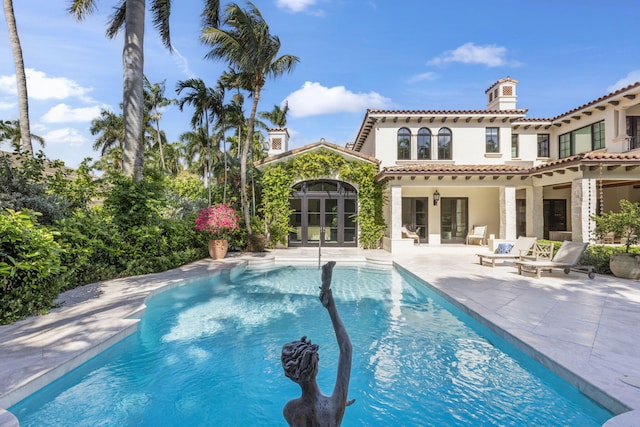 view of swimming pool featuring french doors and a patio