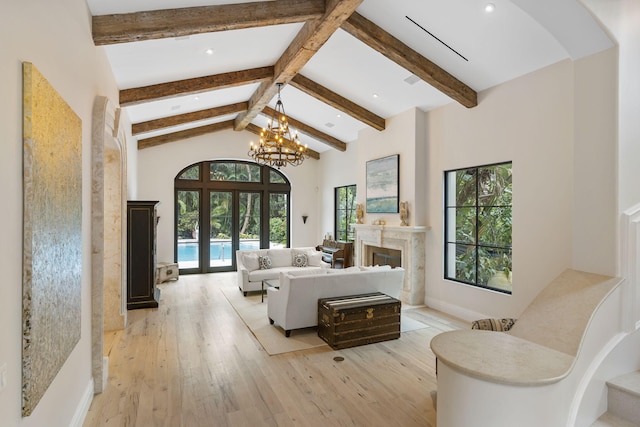 living room with light hardwood / wood-style floors, french doors, high vaulted ceiling, and beamed ceiling