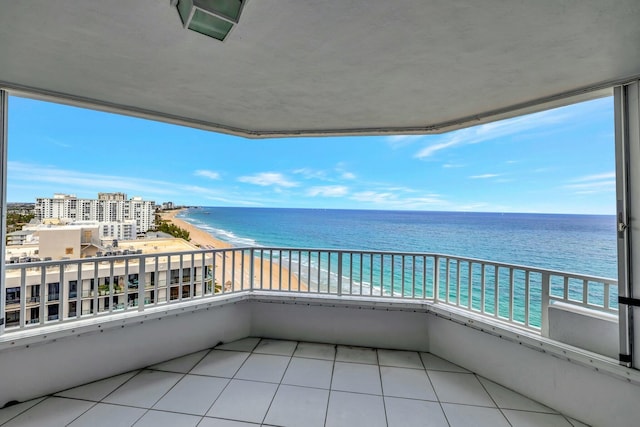 balcony with a beach view and a water view