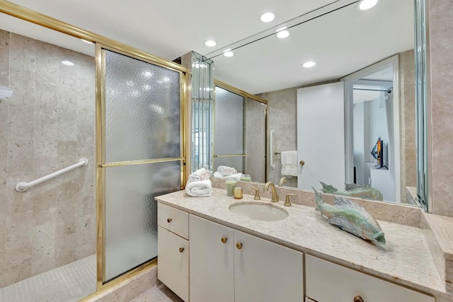 bathroom with an enclosed shower and vanity