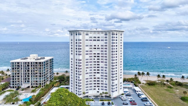 birds eye view of property featuring a beach view and a water view